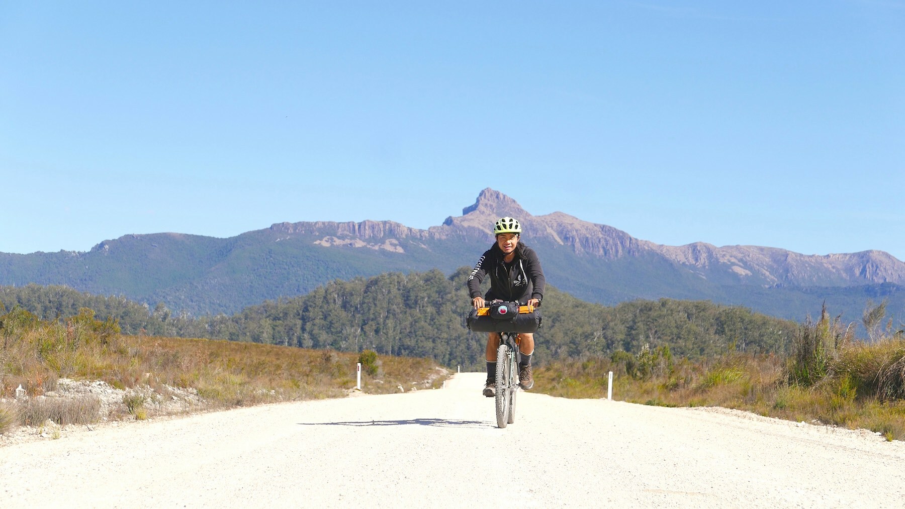 bikepacking in Western Tasmania with the Western Arthur Mountain Range behind