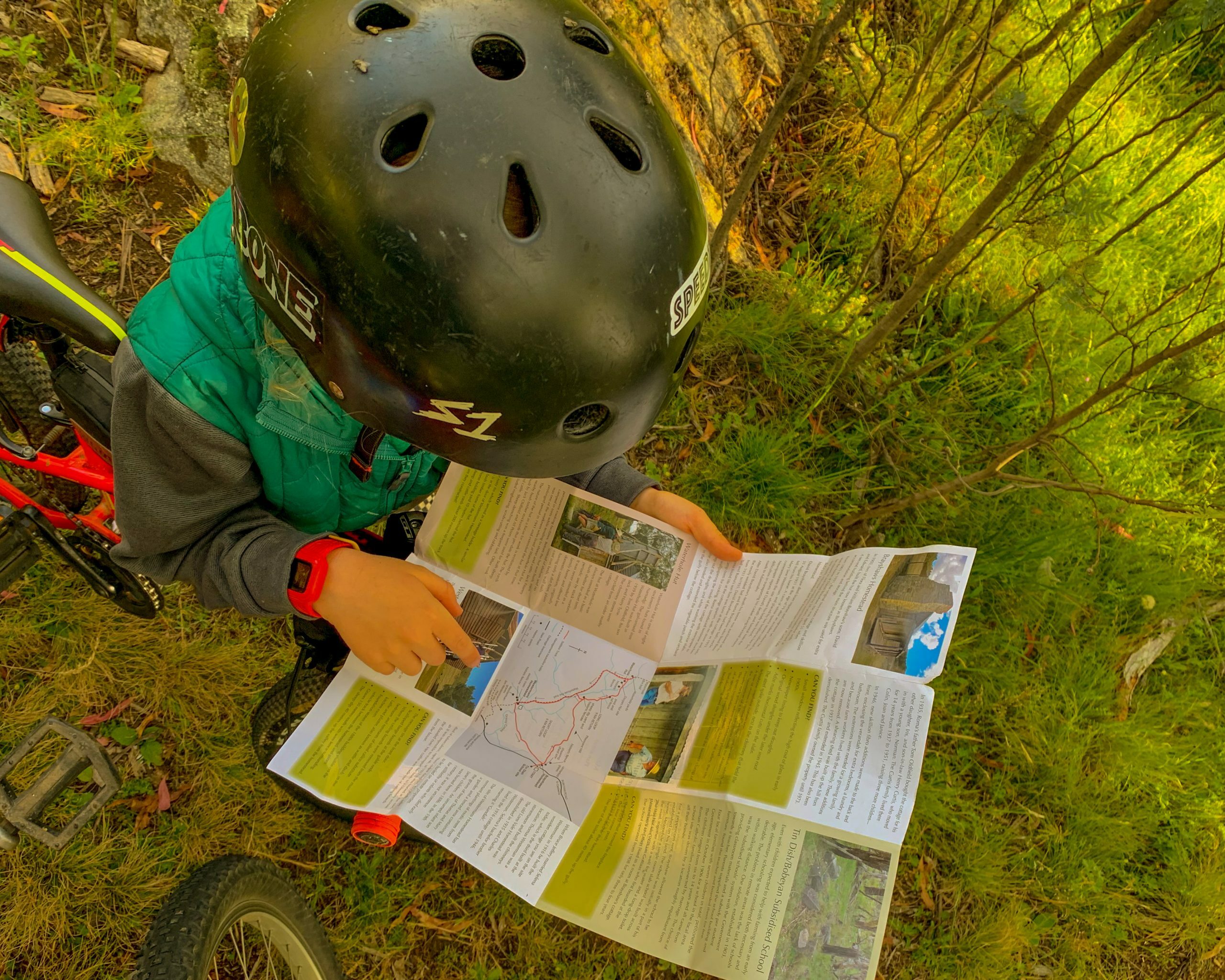 Bikepacking with a six year old , helping to read the map