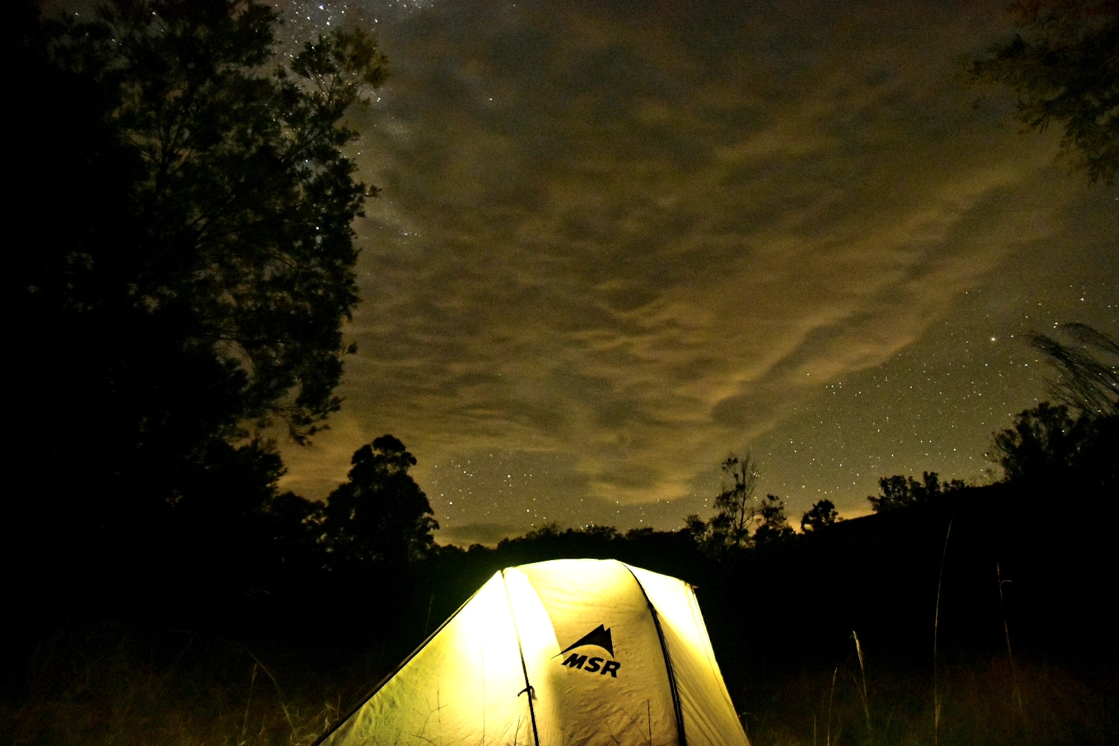 Bikepacking tent under a night sky in Monkerai