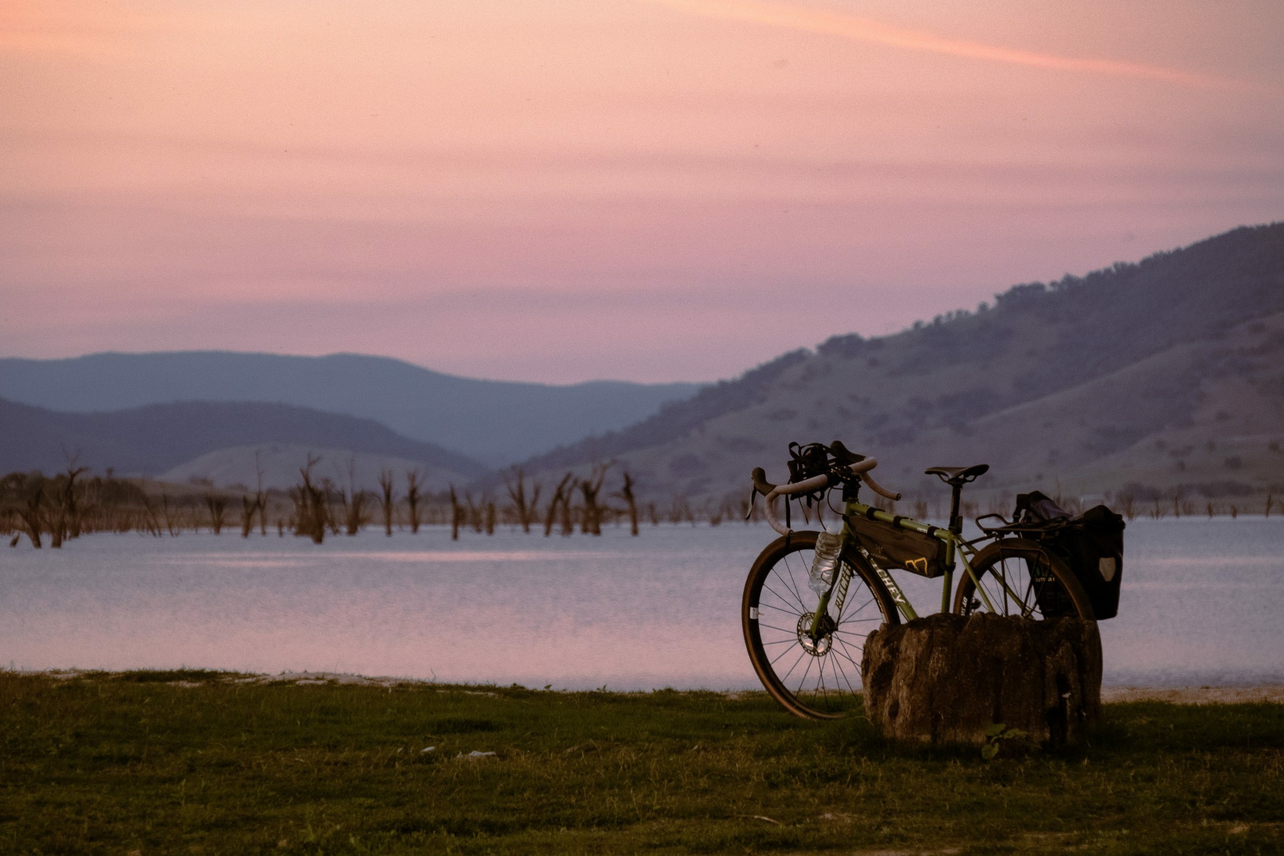 Touring bike and packraft on the banks of the Murray River