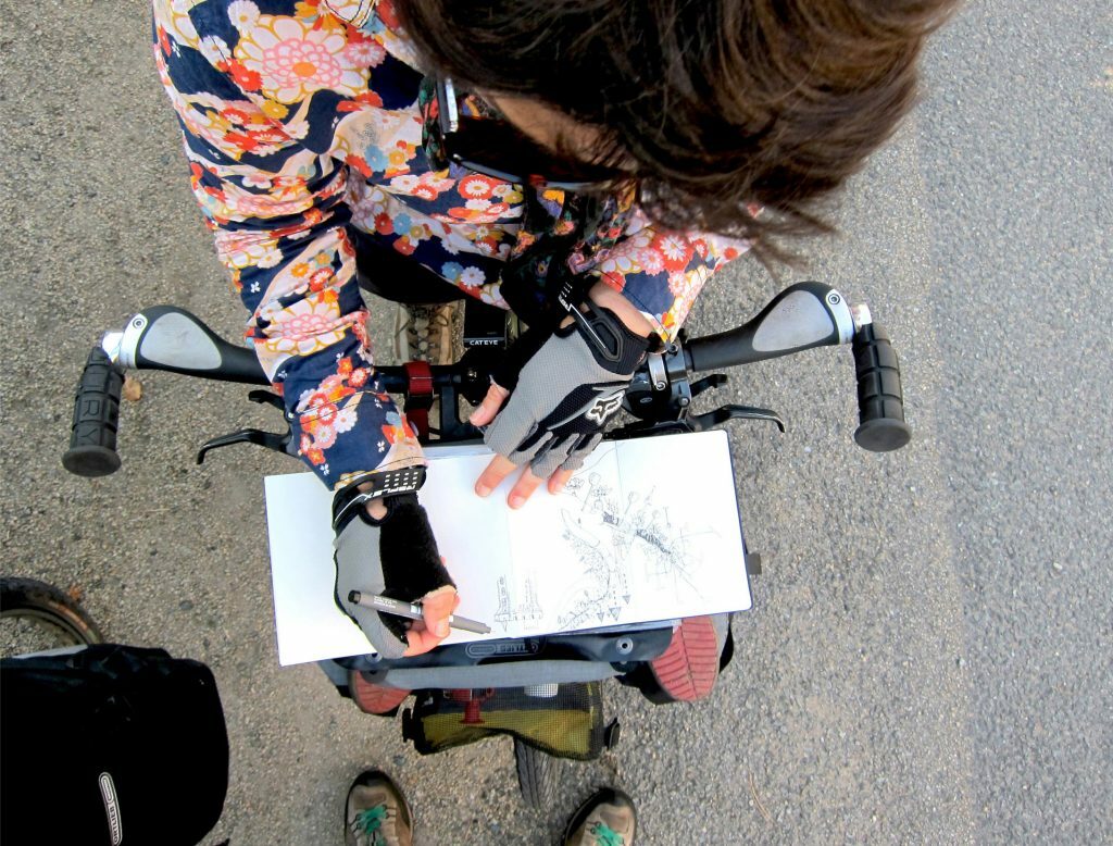 Alex Hotchin drawing on the bike